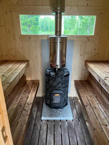 an inside view of a stove in a cabin at Marika Puhkeküla - Nurgatalu Öömaja "shared bathroom" in Nõva