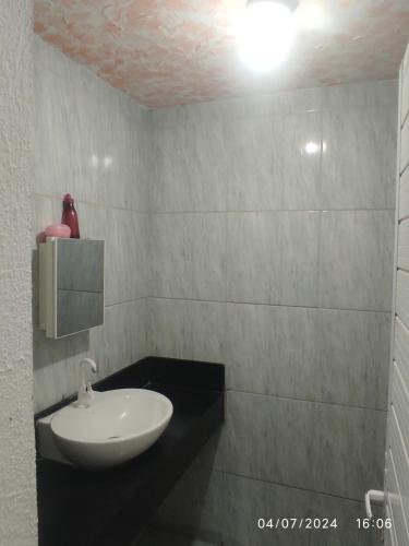 a bathroom with a sink and a toilet in it at Pousada central Russana in Russas