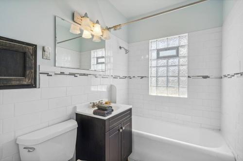 a bathroom with a sink and a tub and a toilet at Classic Majesty in S MPLS in Minneapolis