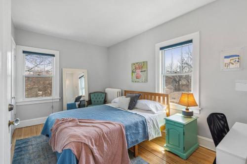a bedroom with a bed and two windows at Classic Majesty in S MPLS in Minneapolis