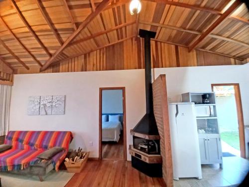 a living room with a couch and a fireplace at Pousada Visconde de Mauá in Visconde De Maua