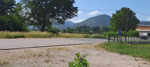 an empty road with mountains in the background at Home-Grahovo in Bobova Ulica