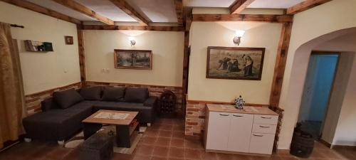 a living room with a couch and a table at Home-Grahovo in Bobova Ulica
