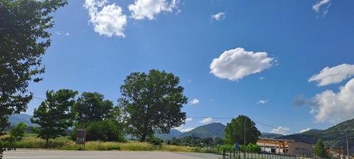 a road with trees and mountains in the background at Home-Grahovo in Bobova Ulica