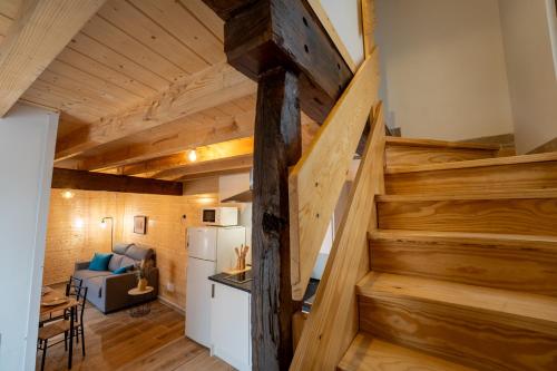 a staircase in a room with a couch and a refrigerator at encanto rural en arce by urbanhosting in Arce