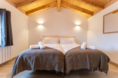 a bedroom with a large bed in a room with wooden ceilings at encanto rural en arce by urbanhosting in Arce