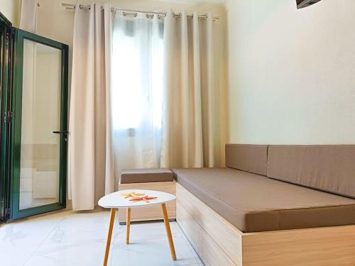 a living room with a couch and a table at Classy Louvis House in Akti Salonikiou