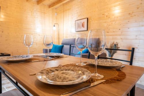 a wooden table with wine glasses on top of it at encanto rural en arce by urbanhosting in Arce