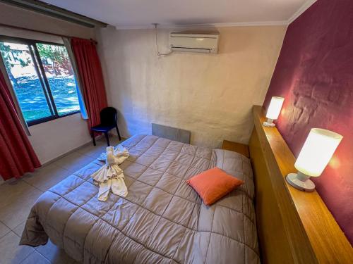 a bedroom with a bed with a bow on it at Cabañas Del Sol in Valle Grande