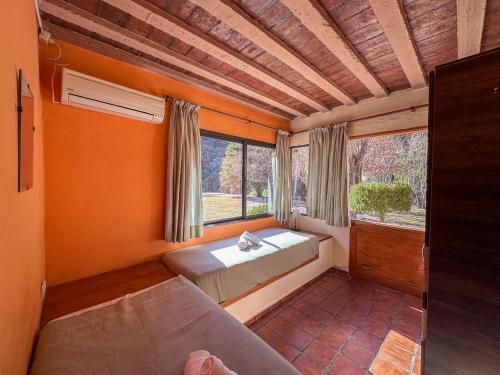 a bedroom with a bed and a large window at Cabañas Del Sol in Valle Grande