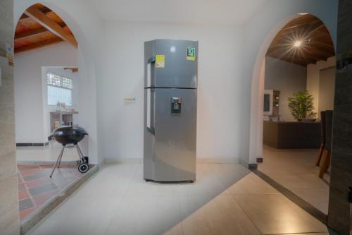 a stainless steel refrigerator in a room with an archway at 5STARHOMES - Estilo y confort en Laureles in Medellín