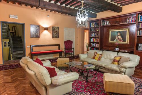 a living room with couches and a piano at Hotel Villa Volpi in Lucca