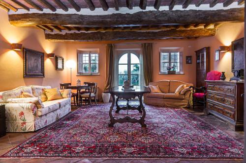 a living room with a couch and a table at Hotel Villa Volpi in Lucca