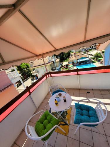 a view of a balcony with a table and chairs at HELEN STUDIOS Loft in Plános