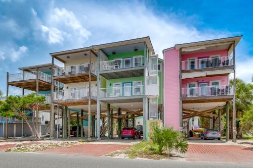 a tall building with colorful balconies on a street at Steps to Beach Waterfront Cedar Key Home! in Cedar Key