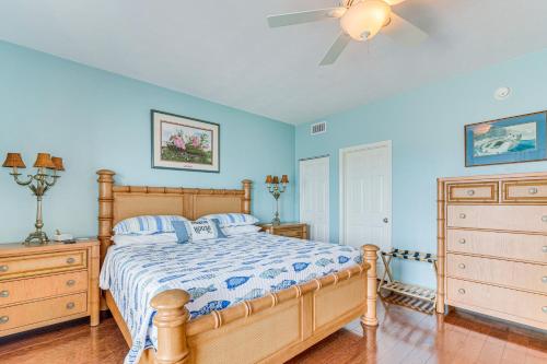 a bedroom with a bed and a ceiling fan at Steps to Beach Waterfront Cedar Key Home! in Cedar Key
