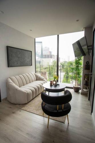 a living room with a couch and a table at São Paulo by MrW in Guadalajara