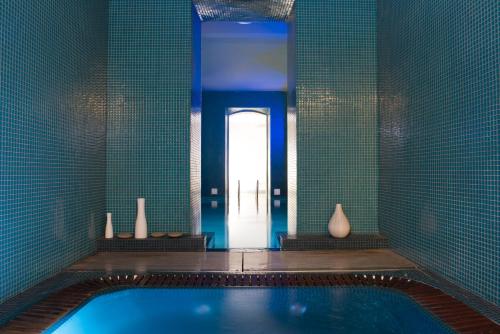 a bathroom with a swimming pool and a door at Hotel C2 in Marseille