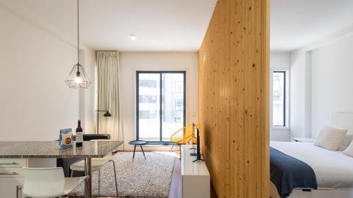 a bedroom with a bed and a desk in a room at Sena 27 by LovelyStay in Porto