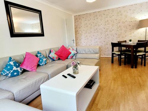 a living room with a couch and a table at Faraday Place in Nottingham