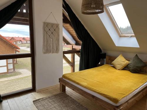 a bedroom with a bed and a large window at Domek na Kaszubach 45-2 - Ostoja Bukowo in Borowy Młyn