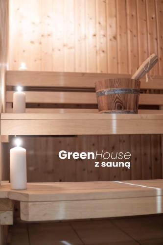 a wooden bench in a room with two candles at Green House - nad jeziorem z pomostem in Olsztyn
