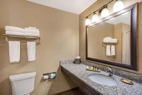 a bathroom with a sink and a toilet and a mirror at Best Western Plus Intercourse Village Inn in Intercourse