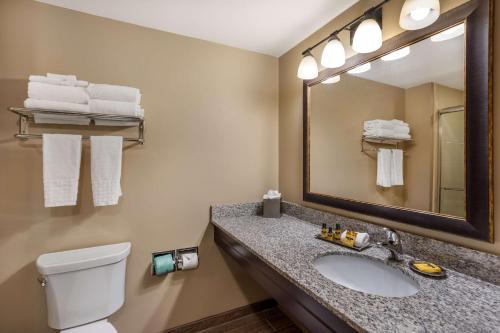 a bathroom with a sink and a mirror and a toilet at Best Western Plus Intercourse Village Inn in Intercourse