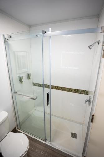 a glass shower in a bathroom with a toilet at Glengarry Extended Stays in Truro