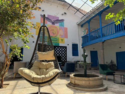 a hammock in the middle of a courtyard at Way Kap Hostel Cusco in Cusco