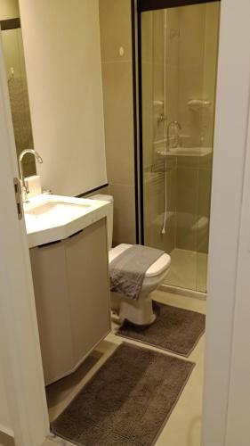 a bathroom with a toilet and a sink and a shower at Studio 306 in Marília