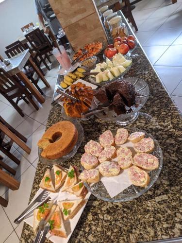 a buffet with plates of food on a counter at Simar Hotel in Araranguá