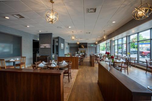 a restaurant with tables and chairs and a bar at Glengarry Extended Stays in Truro