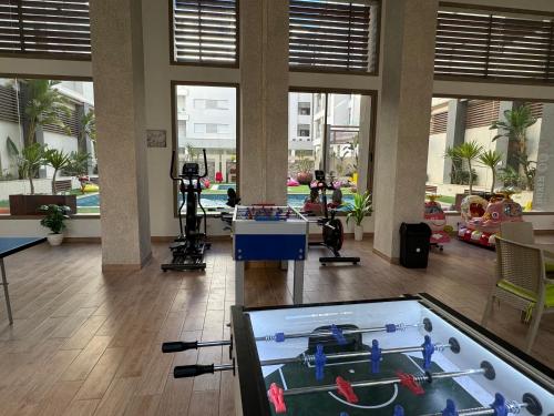 a gym with a pool table in the middle of a room at Dar Mesk & Yasmine in Nabeul