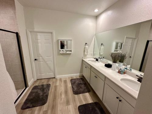 a bathroom with two sinks and a large mirror at Cape Coral-Ft Myers Waterfront Four Bedroom Home in Cape Coral