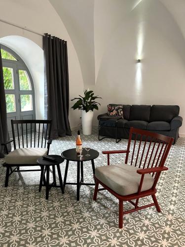 a living room with two chairs and a couch at Palác Daun - Studio Apartments in Znojmo