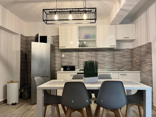 a dining room with a table and chairs and a kitchen at Apartment Potocnica 222a in Novalja