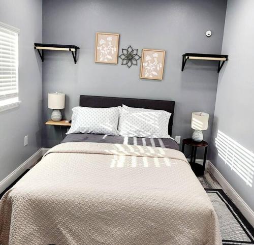 a bedroom with a large bed with two lamps at Green Roof House Studio in Lakeland