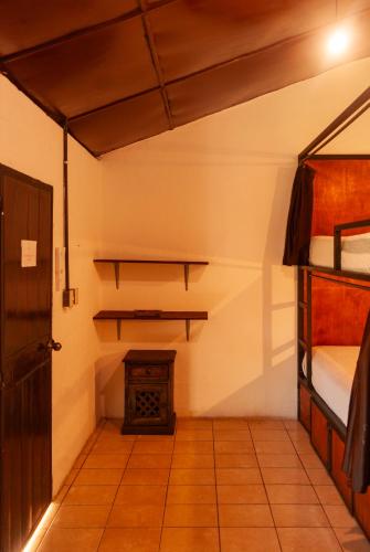 a room with two bunk beds and a stove at Tzunun Hostel in Antigua Guatemala