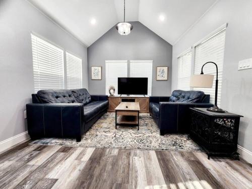 a living room with two couches and a flat screen tv at Green Roof House in Lakeland