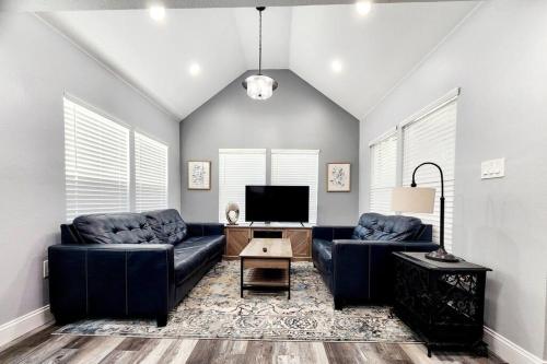 a living room with two couches and a tv at Green Roof House in Lakeland