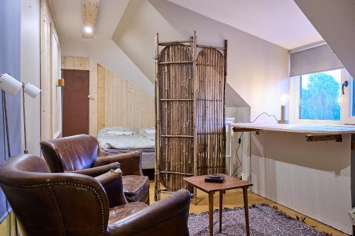 a living room with two chairs and a book shelf at Harmony in Fleninge
