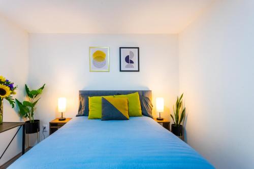 a bedroom with a blue bed with two lamps at Private Room #3 in a 4 bedroom Guest House in Roma Norte, Mexico City in Mexico City