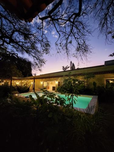 a house with a swimming pool at night at Hotel Boutique Villa Escondida, A Pasos de Lo Mejor en Tlaquepaque in Guadalajara