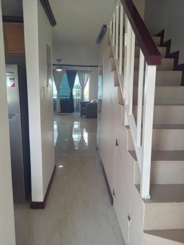 a hallway with stairs in a house at Sea Breeze Penthouse Apartment in Kingston