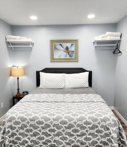 a bedroom with a bed and a clock on the wall at Studio Grande in Lakeland
