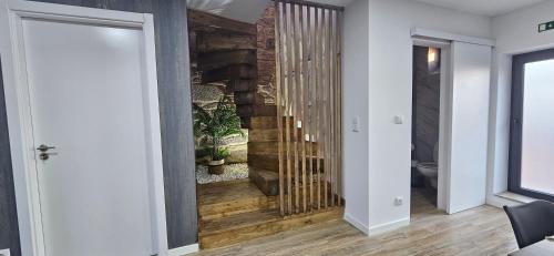 a hallway with a wooden staircase in a house at Vilar Rural Houses - Casa dos Avós in Tangil