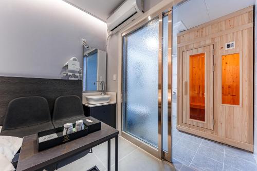 a bathroom with a glass shower and a sink at Hotel the Rest in Cheongju