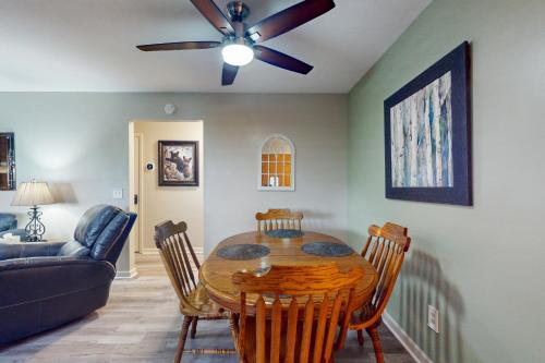 a dining room with a table and a ceiling fan at Hiawassee Hideaway in Hiawassee