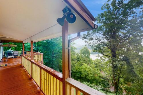 a balcony with a large window looking out into the woods at Hiawassee Hideaway in Hiawassee